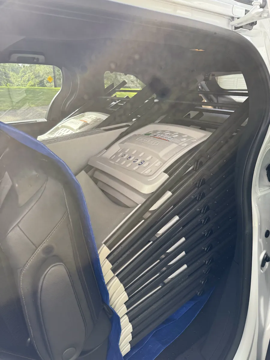 Folding chairs racked upright inside the delivery vehicle