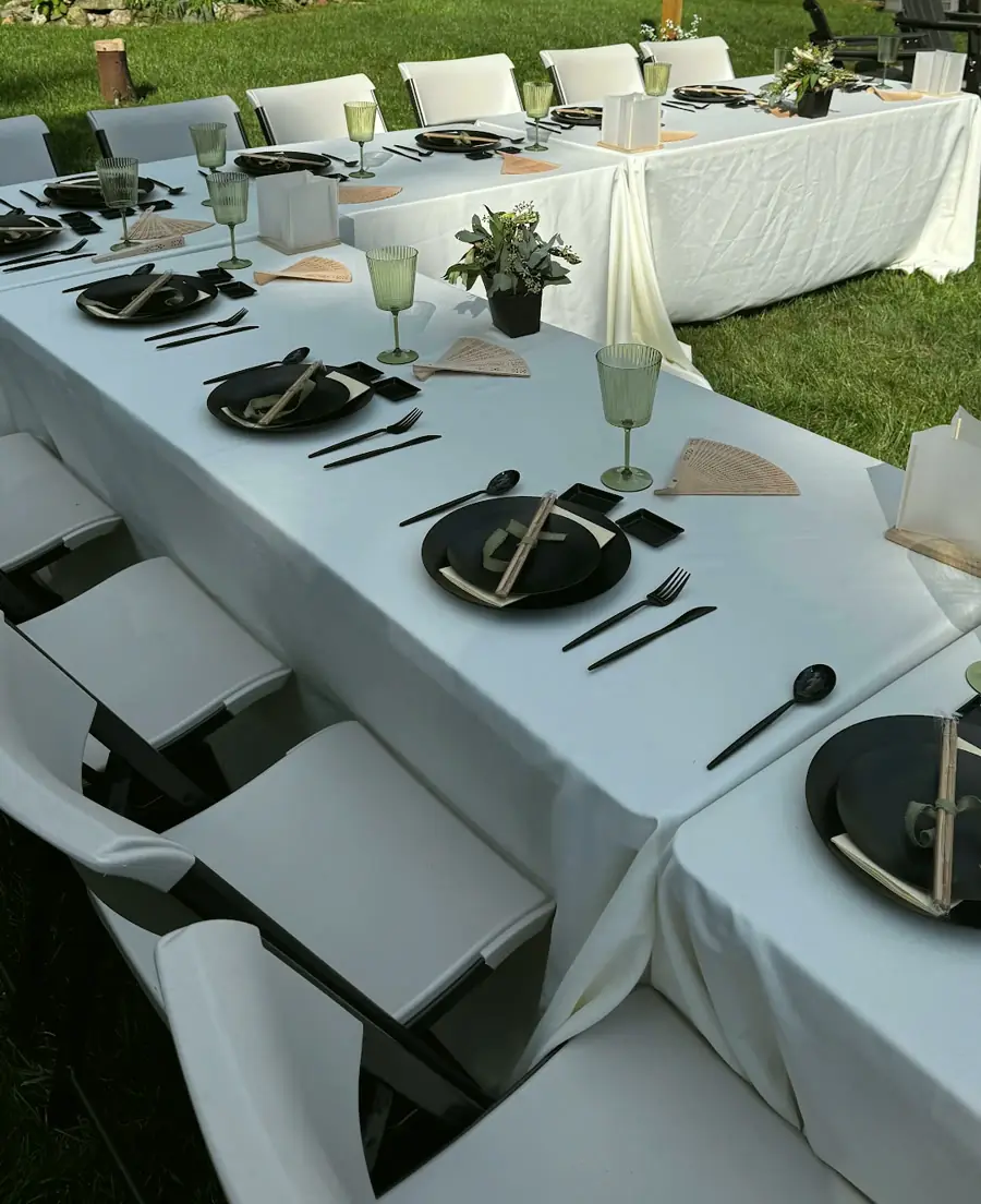 Chip’s backyard dinner: our tables set in a U under the host’s white tablecloths, with our white folding chairs